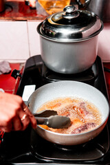 Asian Spring Roll Frying Process in Kitchen Cooking Scene