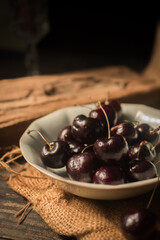 Cherries on a wooden Board, still life in rustic style