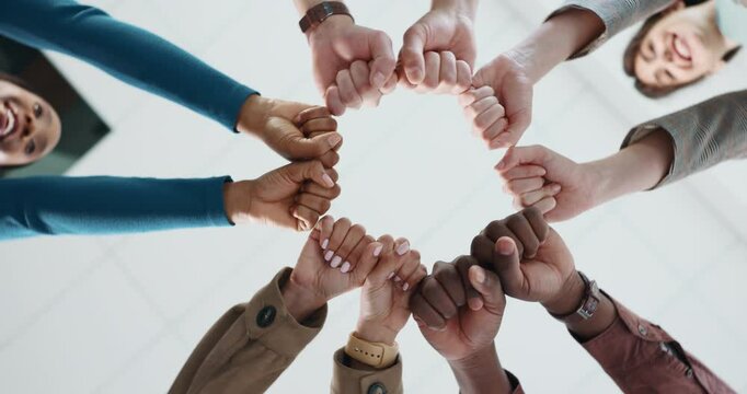 Fist bump, below and hands of business people in office for teamwork, collaboration and support. Professional, startup company and workers in circle for solidarity, cooperation and partnership