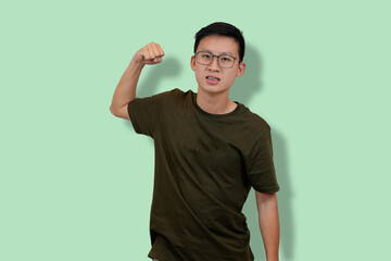 young man giving a punch with his fist in studio background