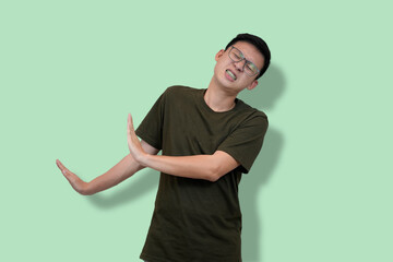 young nerd Man Wearing Glasses Gesturing No Against Green Background