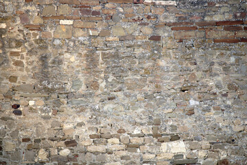 Stone antique old wall as a background or texture. Vintage background of a fortress wall in loft...