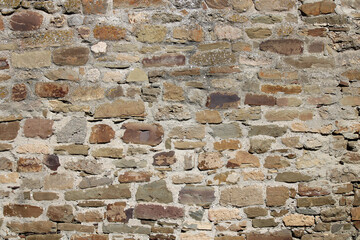 Stone antique old wall as a background or texture. Vintage background of a fortress wall in loft...