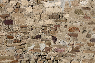 Stone antique old wall as a background or texture. Vintage background of a fortress wall in loft...