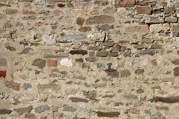 Stone antique old wall as a background or texture. Vintage background of a fortress wall in loft...