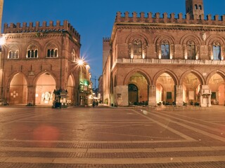 Warm evening light illuminating medieval architecture surrounding Piazza Duomo, revealing historic...