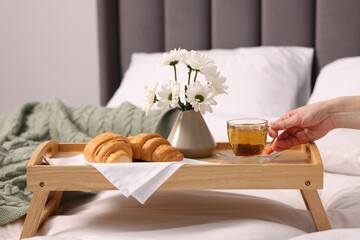 Woman having delicious breakfast in bed, closeup