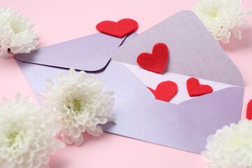 Love letters, flowers and red hearts on pink background, closeup