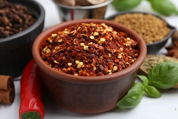 Different aromatic spices on white table, closeup