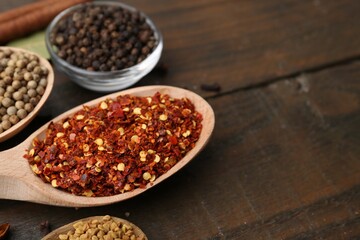 Different aromatic spices on wooden table, closeup. Space for text