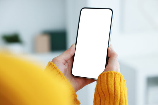 Woman using modern smartphone at home, closeup