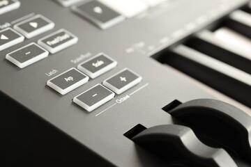MIDI keyboard with buttons and faders, closeup