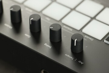MIDI keyboard with buttons and faders, closeup
