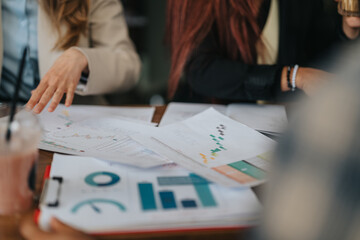 Group of business professionals discussing financial data and strategies at a workplace