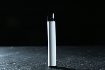 Modern electronic smoking device on black table