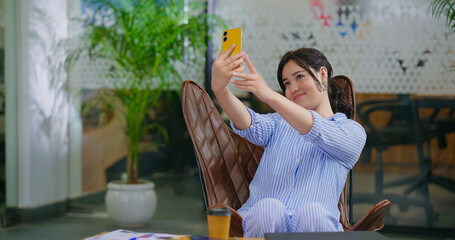 Happy young adult gen z woman lady hold mobile look came take selfie do pose make pout enjoy day at...