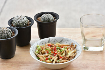  Pupae in bamboo fried crispy insect protein food, appetizer or snack local Thai food, Bamboo Caterpillar is food in street food at northern of thailand.