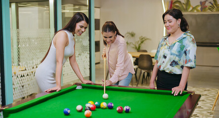Indian happy young adult gen z woman lady hold cue stick hit ball play sport game on pool table...
