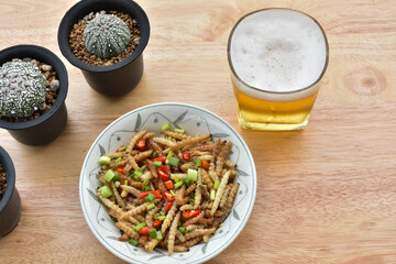  Pupae in bamboo fried crispy insect protein food, appetizer or snack local Thai food, Bamboo Caterpillar is food in street food at northern of thailand.