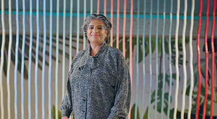 Indian happy old aged gray haired women boss lady leader ceo standing proud look camera indoor work...