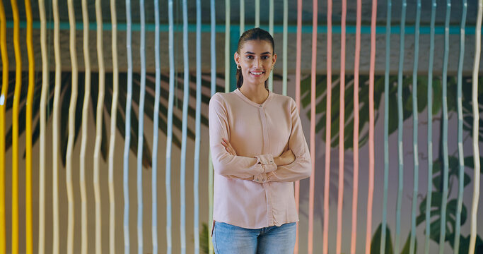 Indian happy young adult gen z proud ceo women intern lady cross arms look camera indoor office place. Asian boss girl expert staff leader fold hands staring cam do casual pose at work job day time