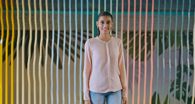 Indian happy young adult gen z proud ceo women intern lady look camera indoor office place. Asian boss girl expert staff leader staring cam do casual pose at work job day time