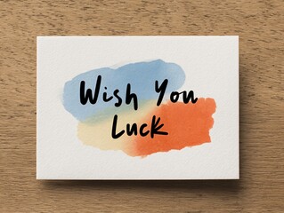 Creative greeting card design featuring wish you luck watercolor splat art studio digital art bright colors top view
