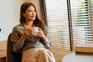 Woman enjoys book and music in modern abode.