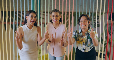 Indian happy diverse proud women lady group team leader look camera indoor show thumbs up at work place young adult female girl staff expert staring cam do pose hand raise job office enjoy day