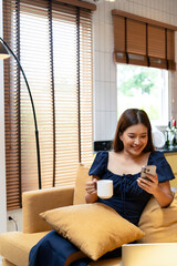 Woman enjoys book and music in modern abode.