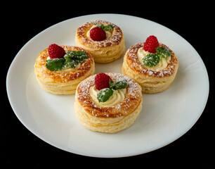 Sweet layered dessert with raspberries and cream in elegant presentation