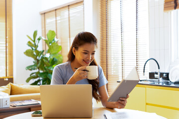 Woman enjoys book and music in modern abode.