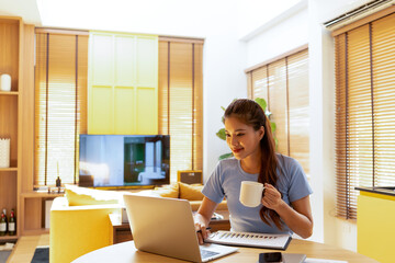 Woman enjoys book and music in modern abode.