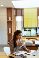 Woman enjoys book and music in modern abode.
