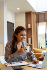 Woman enjoys book and music in modern abode.