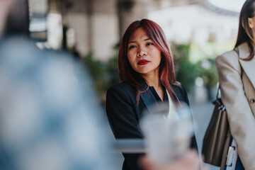 Close-up of business associates discussing during an informal outdoor networking session