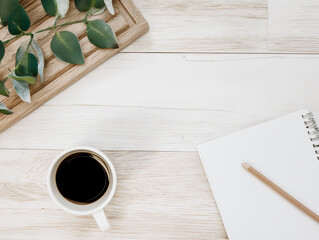 White Wood Desk Workspace with Notepad Coffee and Plant