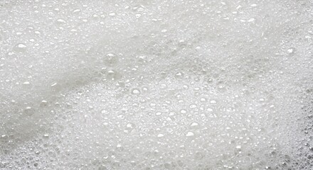 A dense field of small white bubbles creates a frothy and textured surface view