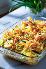 Delicious summer squash casserole baking in glass pan