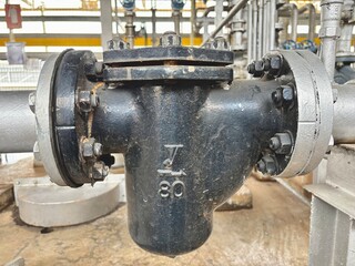 old industrial machine.Industrial pump system with pipeline connections, strainers, and electric motors. Used for fluid transport in factories, water treatment, chemical plants, or energy production s