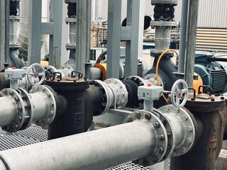 Industrial pump system with pipeline connections, strainers, and electric motors. Used for fluid transport in factories, water treatment, chemical plants, or energy production systems.
