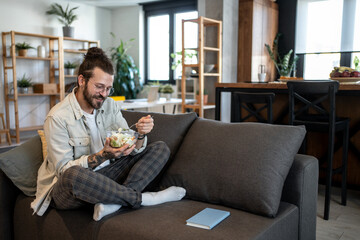 Freelancer enjoying healthy salad while working from home