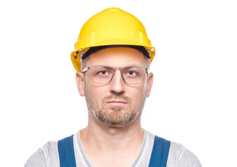 Head and shoulders shot of serious middle-aged construction worker, isolated on white background. Front view. Portrait of friendly repairman with blank expressions face. Craftsman against white wall