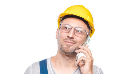Closeup middle-aged construction worker on the mobile phone talking, isolated on white background. Joyful repairman talks on smartphone. Craftsman against white wall
