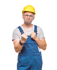 Middle aged construction worker with clenched fists, isolated on white background. Power concept. Studio shot