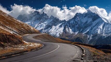 Winding Asphalt Road Journey Through Majestic Snow Capped Mountains Scenic Landscape