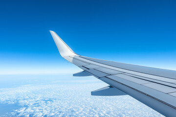 Airplane wing soaring above fluffy clouds against a clear blue sky aircraft flight