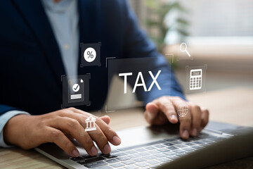 Tax and Vat concept. Government, state taxes concept. Businesman using calculator and laptop to complete Individual income tax return form online for tax payment. Data analysis, financial research.