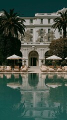Elegant luxury hotel with classical architecture and relaxing outdoor pool area under clear sky
