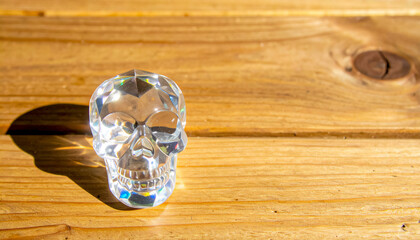 Crystal skull on the table surface, for advertising, with space for text